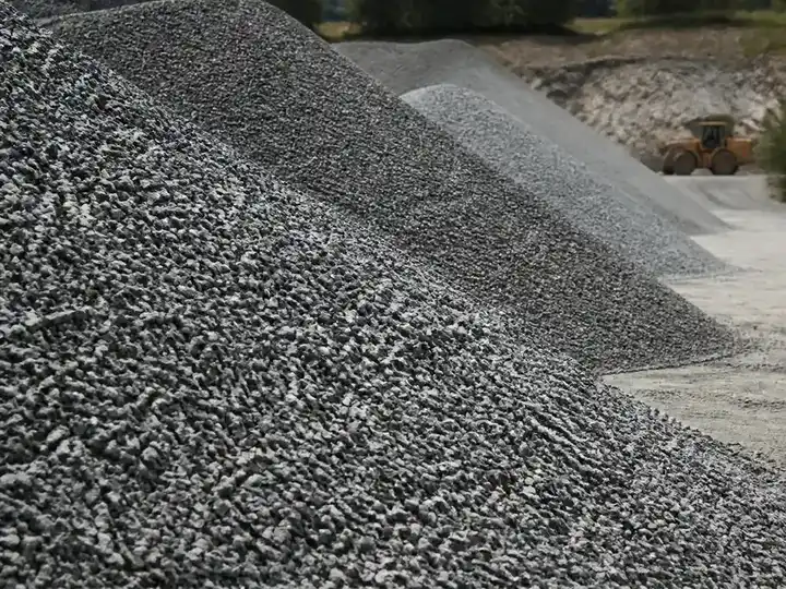 Sorted crushed-stone aggregate piles at a quarry yard